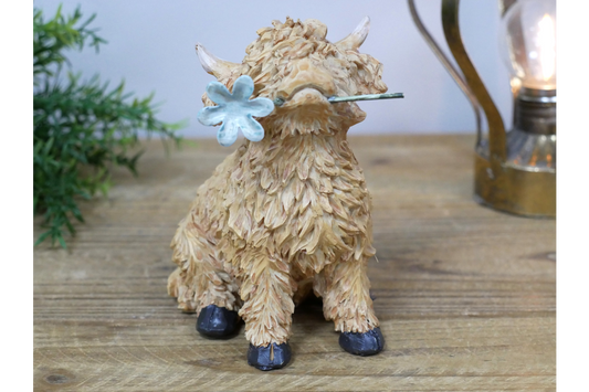 Sitting Highland Cow with Flower